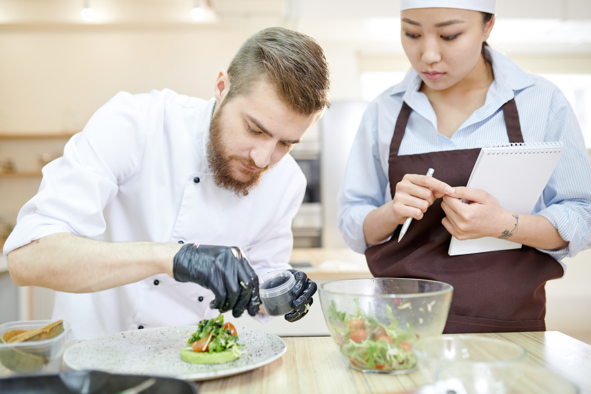 Instructor and participant reviewing plated dish
